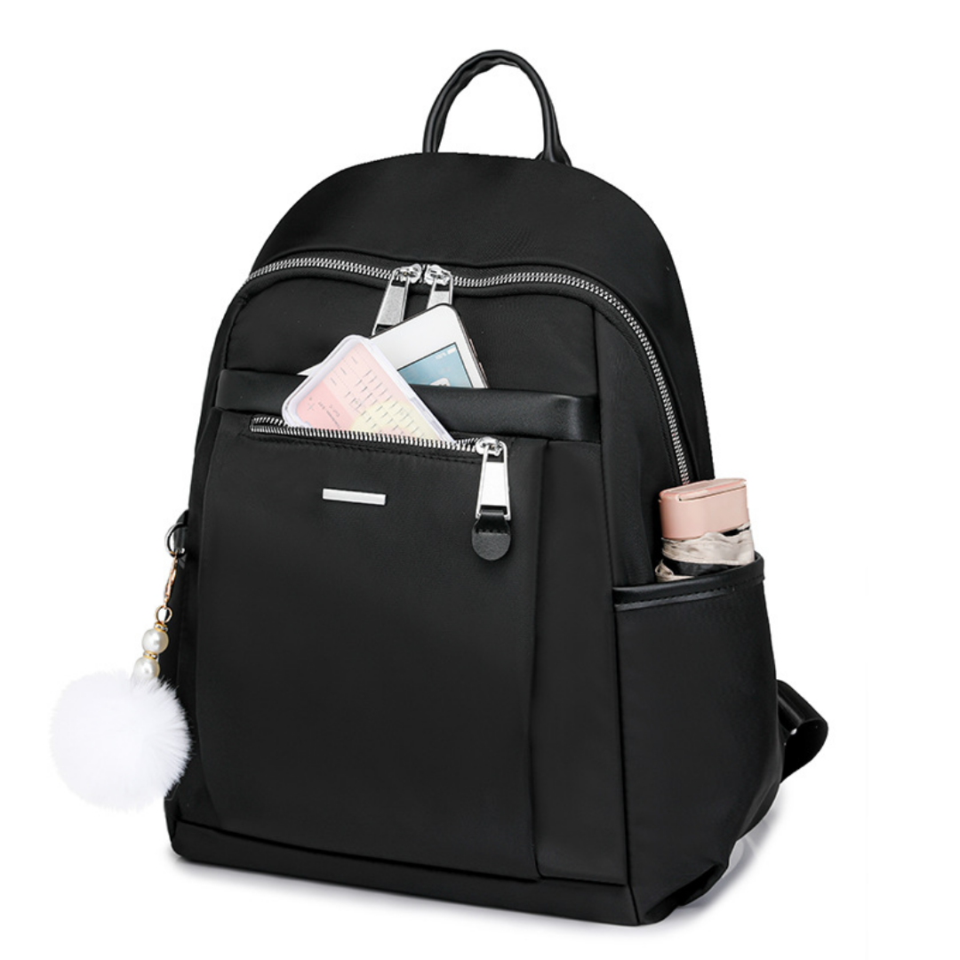 Mochila en tela con compartimentos, llavero pompón y asa superior