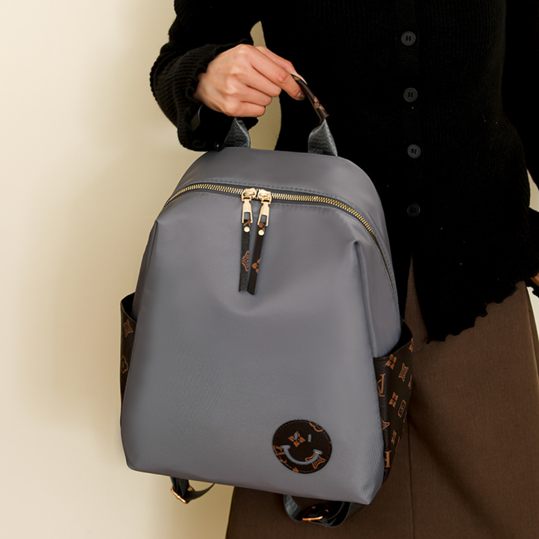 Mochila en tela con parche con carita sonriente, bolsillos laterales en marron